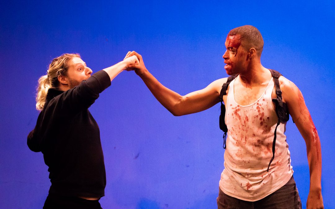 Matt Pick as Karl and Wade F. Wilson as John McClane (covered in our no-stain stage blood recipe) in Theatre Unleashed's award-wining production of A Very DIE HARD Christmas, presented at studio/stage for the 2018 Hollywood Fringe Festival. Directed by Gregory Crafts. Photo by Matt Kamimura