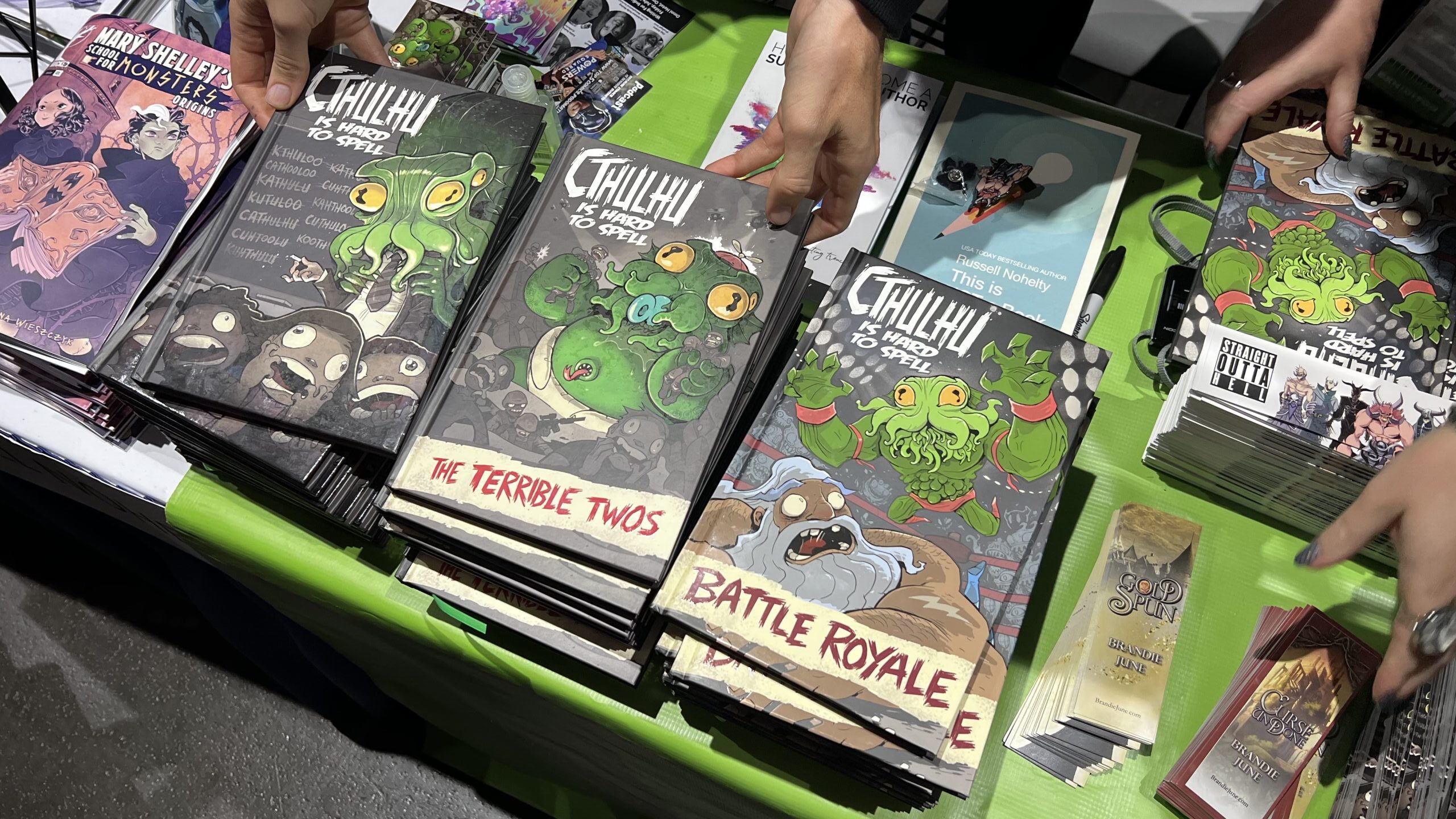 All three volumes of Cthulhu is Hard to Spell at the Wannabe Press booth at San Diego Comic Con 2023